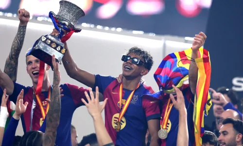 amine Yamal of FC Barcelona celebrates with the Supercopa de Espana trophy - Getty Images.png